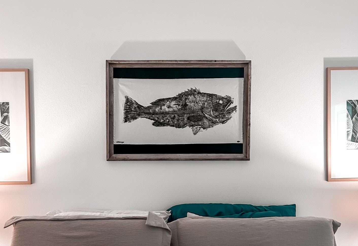 Framed gyotaku print of a black grouper displayed above bed in coastal-style bedroom – Japanese fish art for nautical home decor